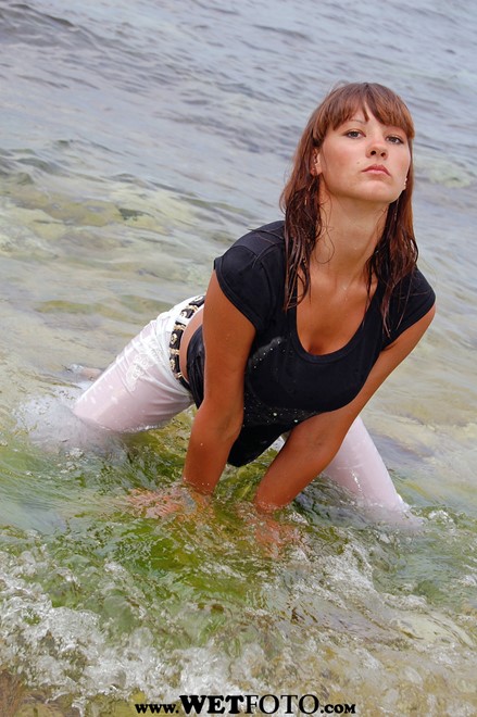 wet girl get wet wet hair fully clothed t-shirt pants high heels sea