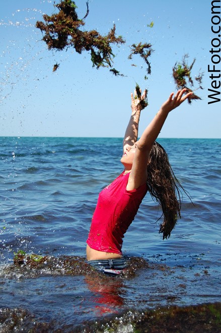 wet girl get wet wet hair swim fully clothed jeans blouse high heels sea