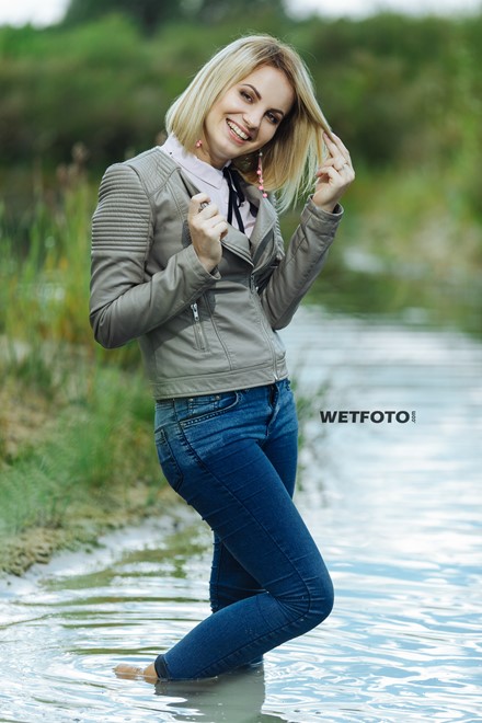 blonde wet girl swim fully clohed wet hair blouse skinny jeans jacket high heels lake